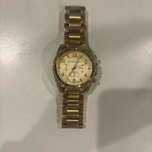 Michael Kors gold watch with faux diamonds around the face